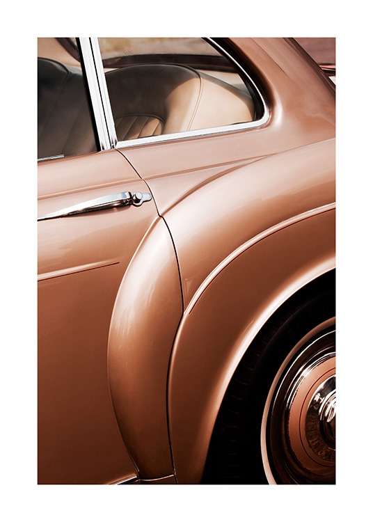  - Photographie avec un gros plan sur une voiture ancienne en marron bronzé avec des détails argentés