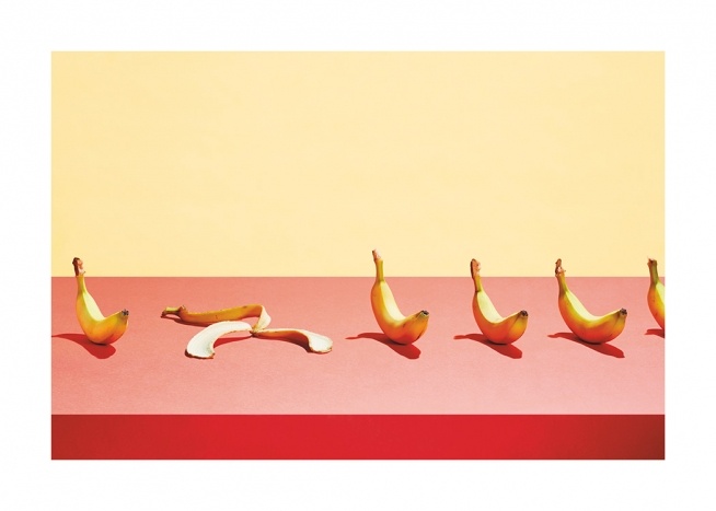  – Photographie d’une rangée de bananes posées sur une table rose avec un fond jaune