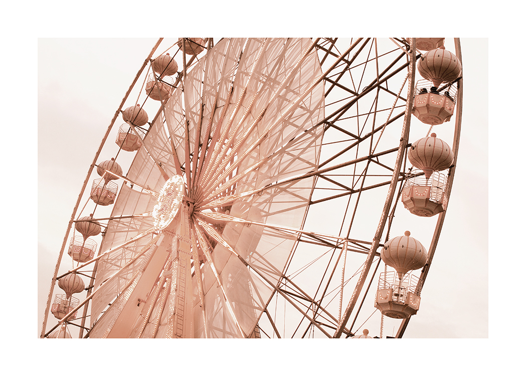  – Photographie d’une grande roue en rose avec un ciel beige clair à l’arrière-plan
